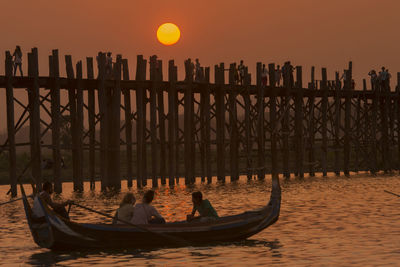 Pier on sea at sunset