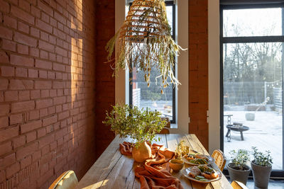 Glass of table by window at home