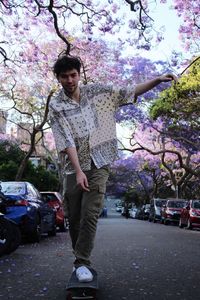 Portrait of young man standing on street