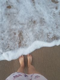 Low section of woman relaxing on beach