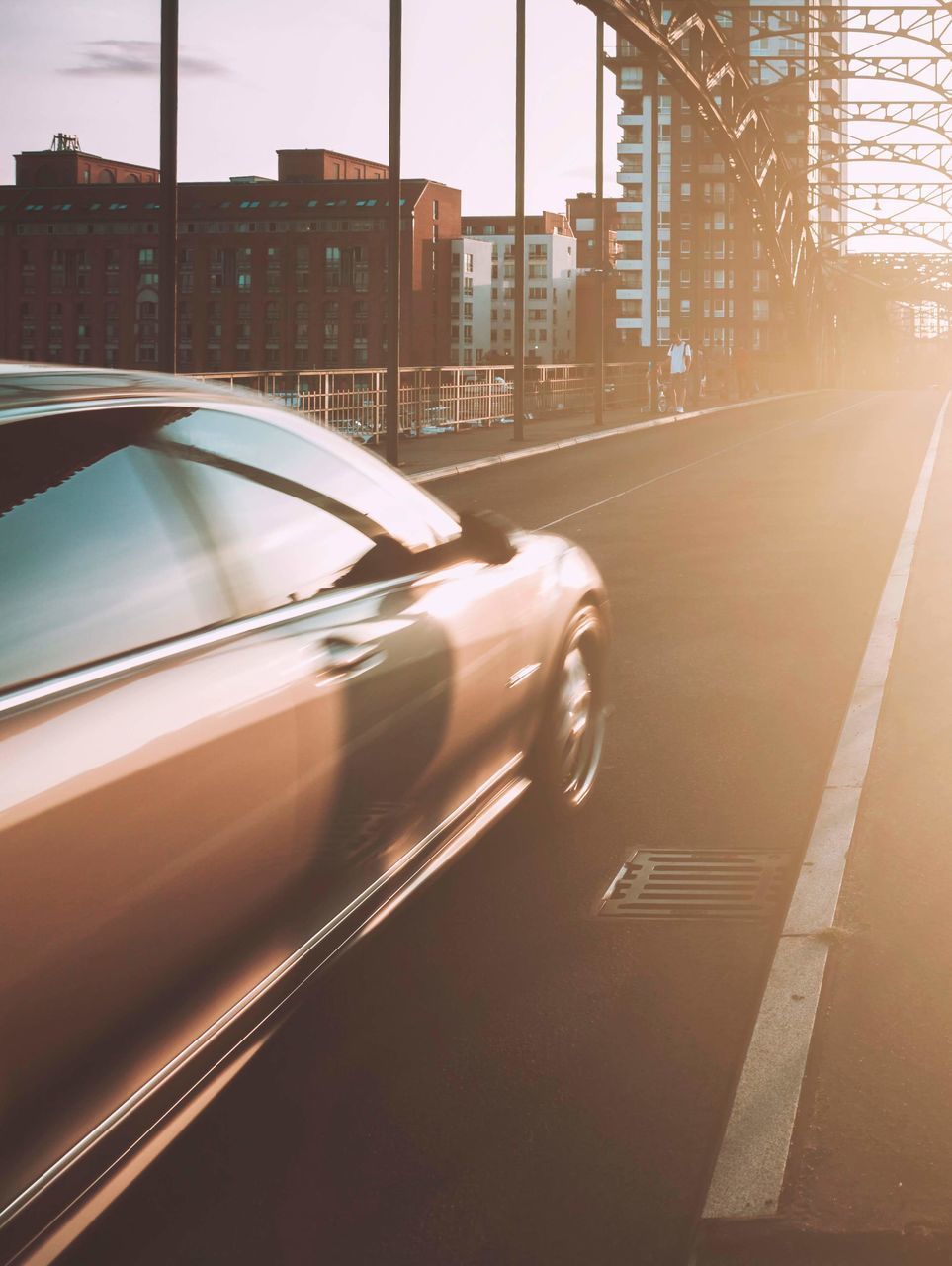 BLURRED MOTION OF CAR ON ROAD IN CITY