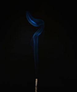 Close-up of smoke emitting from black background