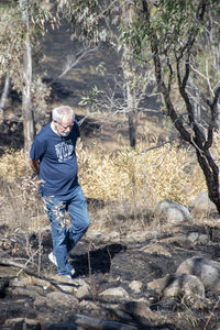 Full length of man standing in forest