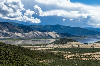 Scenic view of landscape and mountains against sky