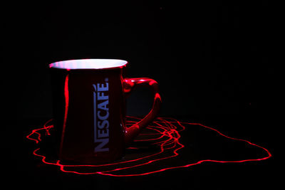 Close-up of coffee cup against black background