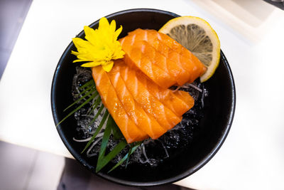 High angle view of salmon  sashimi in plate on table