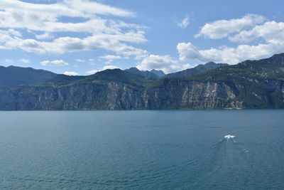 Scenic view of sea and mountains against sky