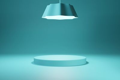 Close-up of illuminated lamp against blue background