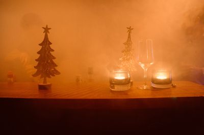 Tea light candles on table against wall