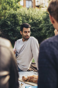 Young man having rooftop party with friends