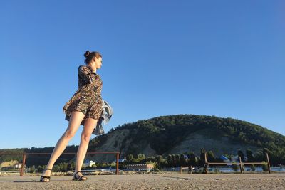 Mountain landscape with clear sky and a girl