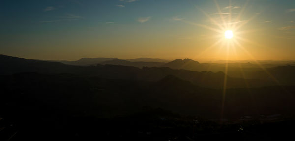 Scenic view of silhouette mountains against sky during sunset