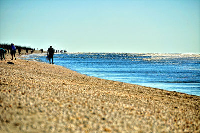 Scenic view of beach against clear blue sky