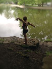 Full length of young woman jumping