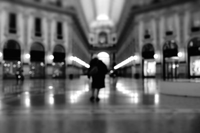 Full length of woman in illuminated city at night