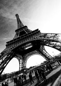 Low angle view of tourists against sky