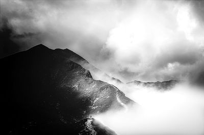 Scenic view of mountains against cloudy sky