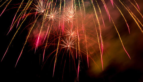 Low angle view of firework display at night