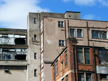 Low angle view of abandoned building against sky