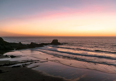 Scenic view of sea against clear sky during sunset