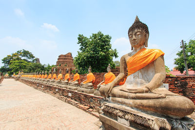 Buddha statues against sky at wat yai chai mongkhon