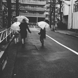 Woman standing on road in city