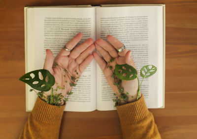 Low section of woman with book on table