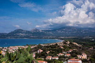 High angle view of townscape by sea against sky