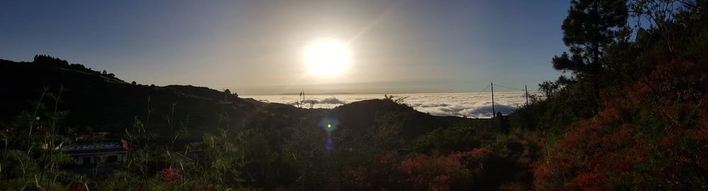 Panoramic view of landscape against bright sun