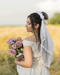 Portrait of bride holding bouquet