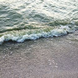 High angle view of waves rushing towards shore