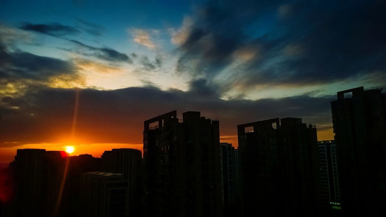 building exterior, sunset, architecture, built structure, city, sky, cloud - sky, silhouette, skyscraper, building, cityscape, sun, orange color, urban skyline, residential building, cloud, cloudy, office building, sunlight, modern