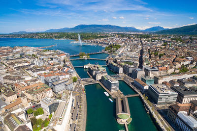 High angle view of townscape by sea against sky