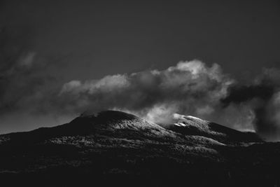 Smoke emitting from volcanic mountain against sky