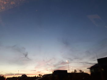 Low angle view of silhouette buildings against sky at sunset