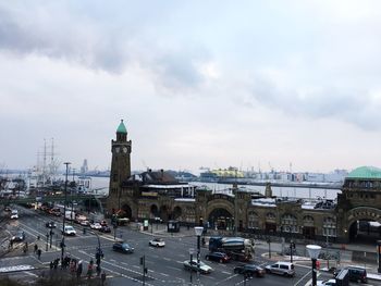 View of city buildings against cloudy sky