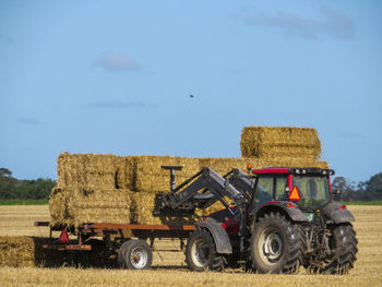 Tractor on field against sky