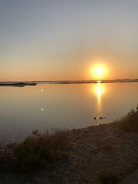Scenic view of beach against sky during sunset