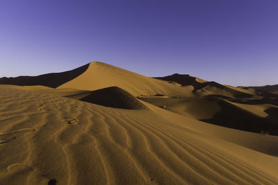 Scenic view of desert against clear sky