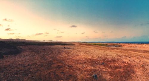 Scenic view of beach against sky during sunset