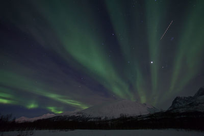 Scenic view of aurora borealis over lyngen alps