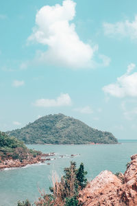 Scenic view of sea and mountains against sky