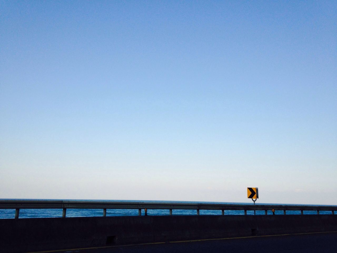 transportation, built structure, copy space, clear sky, mode of transport, bridge - man made structure, architecture, connection, outdoors, sky, engineering, no people, low angle view, day, travel, railing, nature, public transportation, dusk, guidance