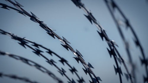 Barbed wire fence against sky