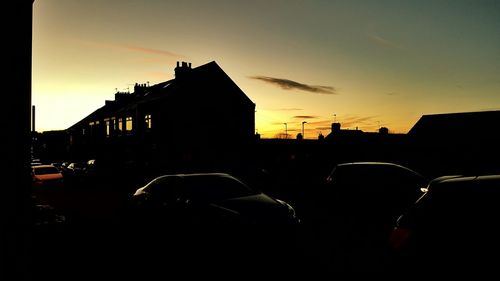 Buildings in city at sunset