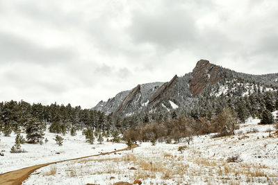 Spring snowstorm covers mountain range and flat irons of chautauqua park . boulder, colorado 