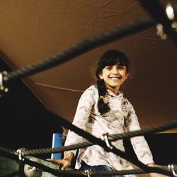 Portrait of smiling girl at jungle gym