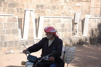 Man sitting against wall