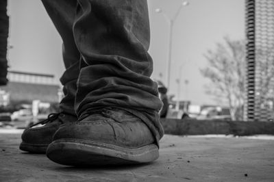 Low section of man standing in city