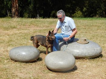 Man with dog sitting on seat